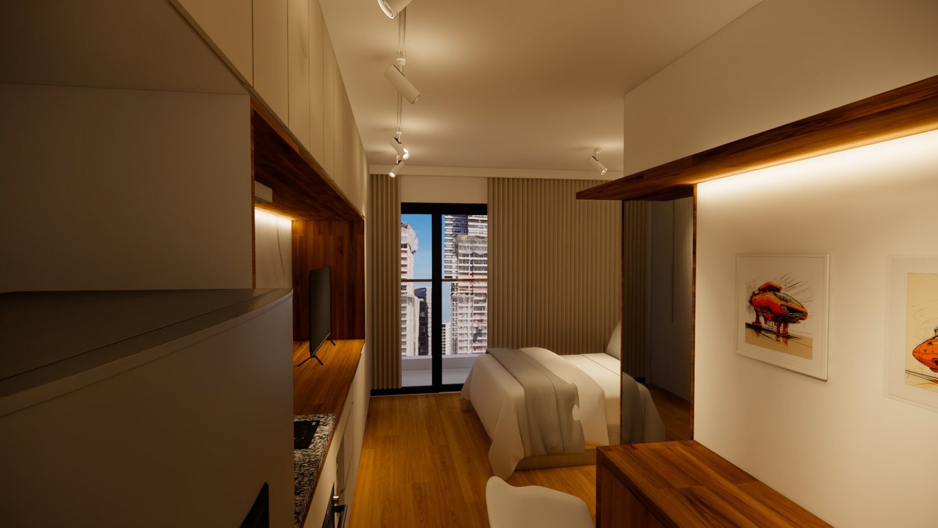 Studio visto da entrada, com a cama junto à janela, nicho de madeira iluminado e quadros na parede